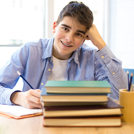 Smiling teen boy with traditional metal braces