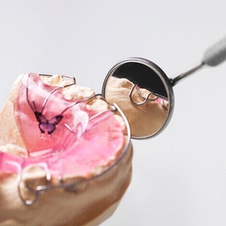 Dental mirror pointing to a bite plate in Rutland on model jaw