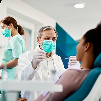 Rutland orthodontist smiling at patient during exam