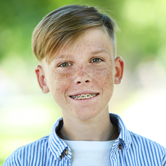Preteen boy receiving dentofacial orthopedics treatment