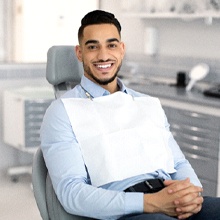 Man in blue shirt smiling at dentist’s office