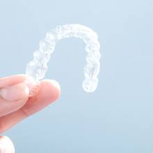 Patient holding up Invisalign in Rutland