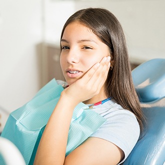 Girl visiting Rutland orthodontist for dental pain with braces