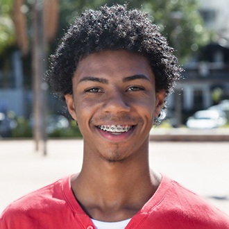 Smiling young man with braces from Rutland orthodontist 